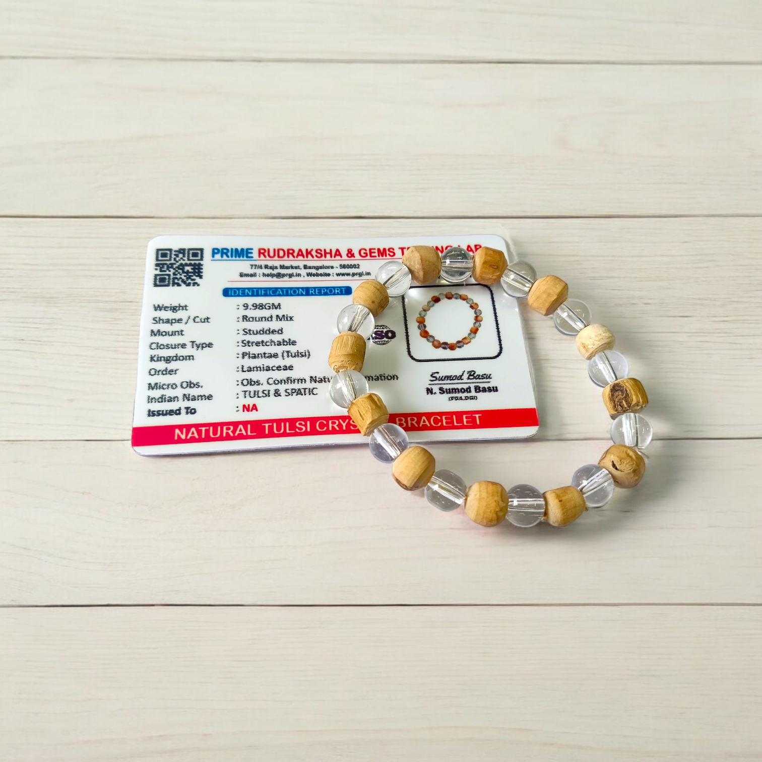 A stretchable 8mm beaded bracelet made from natural Tulsi and Sphatik crystals, ideal for spiritual and healing use, placed against a white background