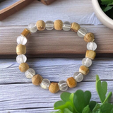A stretchable 8mm beaded bracelet made from natural Tulsi and Sphatik crystals, ideal for spiritual and healing use, placed against a white background