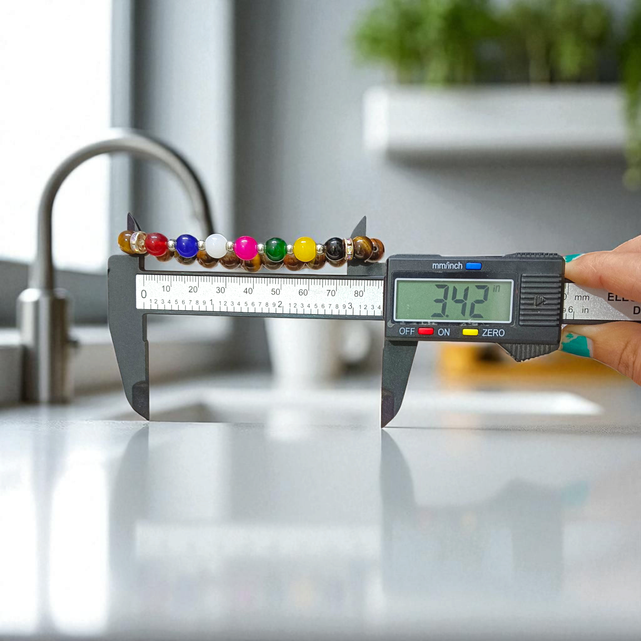 A stretchable bracelet made with 7 types of agate stones (Hakik) and natural Tiger Eye beads, featuring 8mm polished stones—perfect for protection, focus, and healing