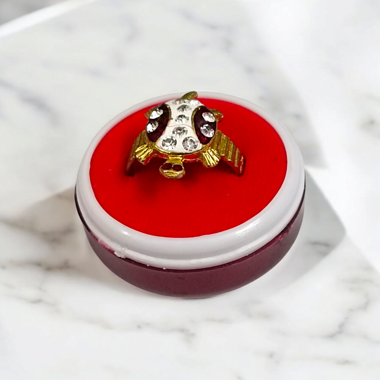 A stylish Tortoise Ring, featuring white zircon stones set in a gold-plated design, symbolizing wisdom, stability, and longevity.

