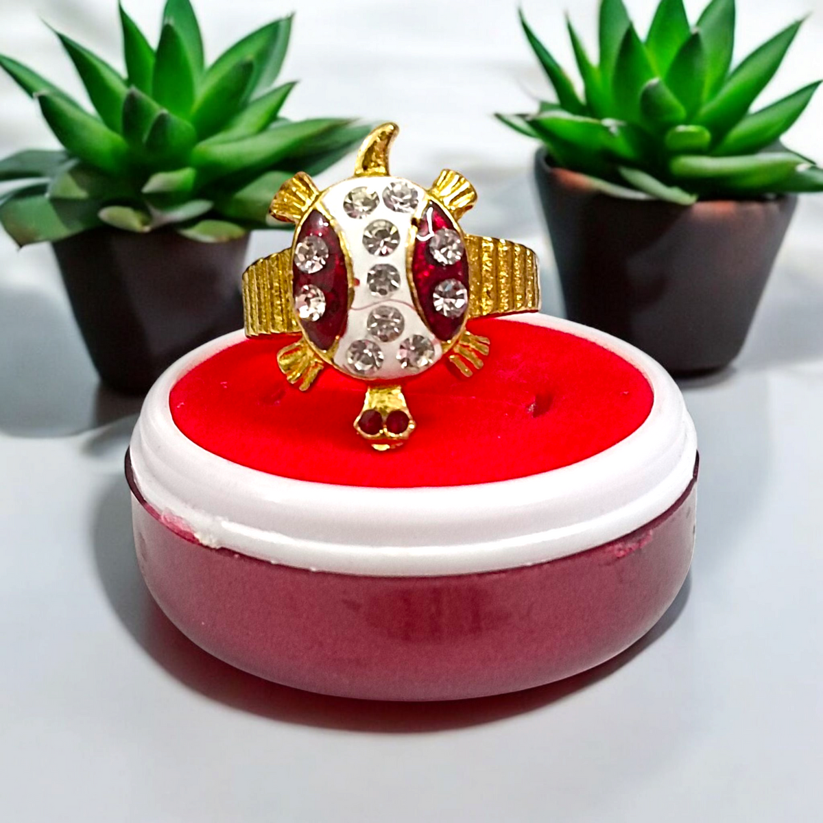 A stylish Tortoise Ring, featuring white zircon stones set in a gold-plated design, symbolizing wisdom, stability, and longevity.

