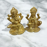 An intricately designed Lakshmi and Ganesh idol in brass, 100% gold plated, showcasing detailed craftsmanship. Perfect for puja or home decoration.

