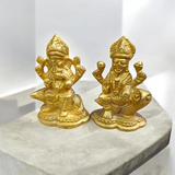 An intricately designed Lakshmi and Ganesh idol in brass, 100% gold plated, showcasing detailed craftsmanship. Perfect for puja or home decoration.

