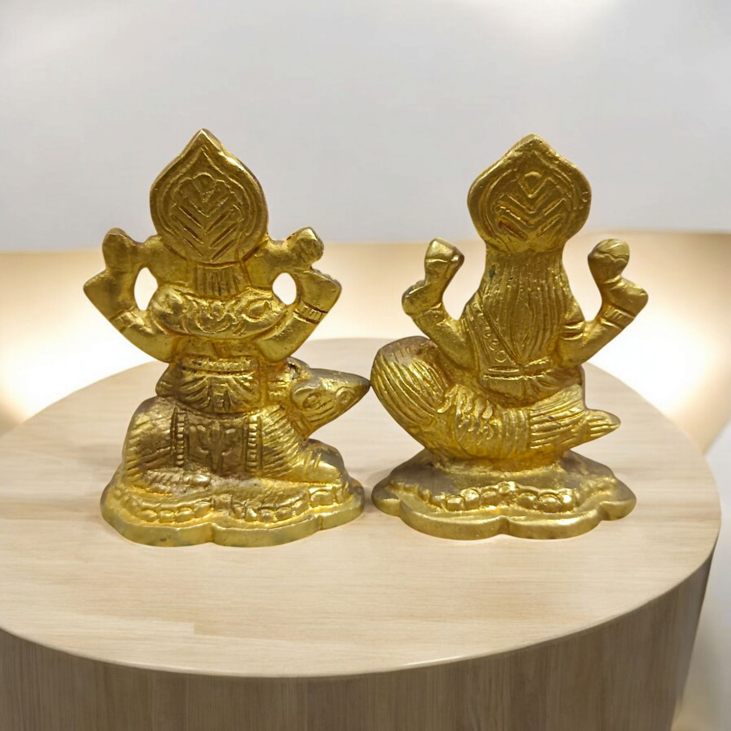 An intricately designed Lakshmi and Ganesh idol in brass, 100% gold plated, showcasing detailed craftsmanship. Perfect for puja or home decoration.


