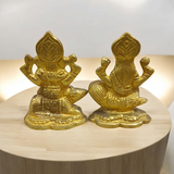 An intricately designed Lakshmi and Ganesh idol in brass, 100% gold plated, showcasing detailed craftsmanship. Perfect for puja or home decoration.

