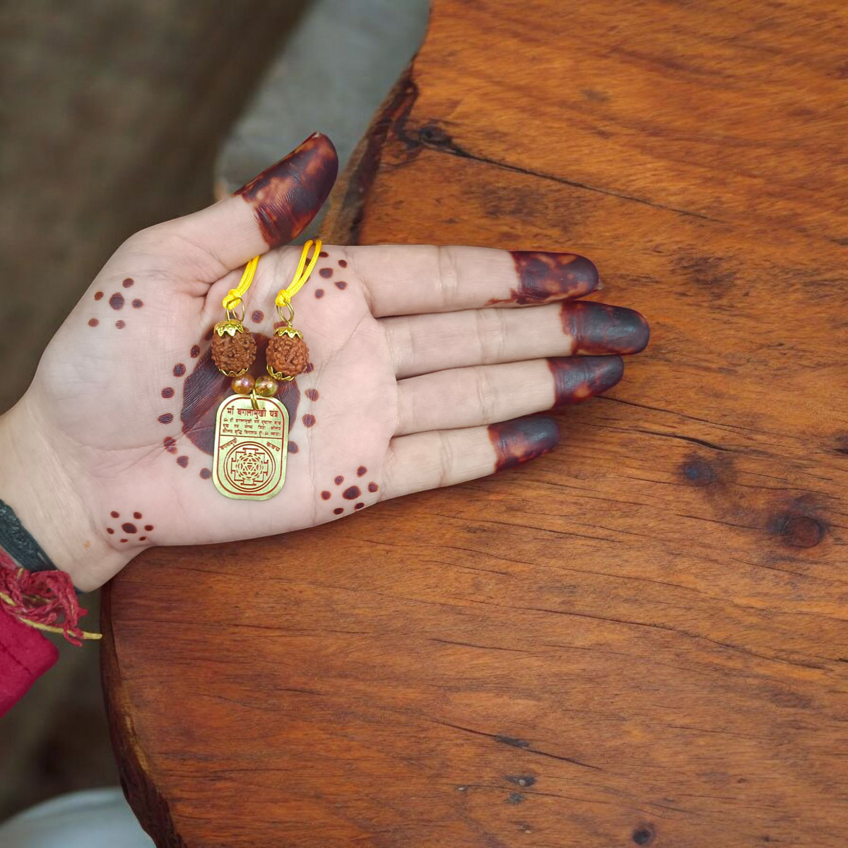 Baglamukhi Kawach Pendant on yellow thread, protection amulet for overcoming obstacles and shielding from negative energies.