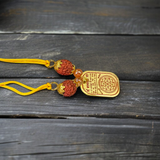 Baglamukhi Kawach Pendant on yellow thread, protection amulet for overcoming obstacles and shielding from negative energies.