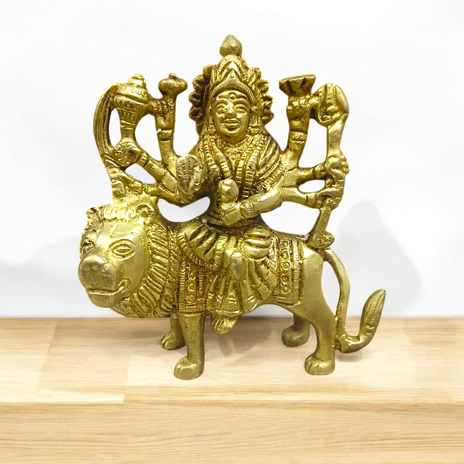 Brass Durga Mata Murti, depicting Goddess Durga on a lion, intricately crafted for worship and spiritual protection.