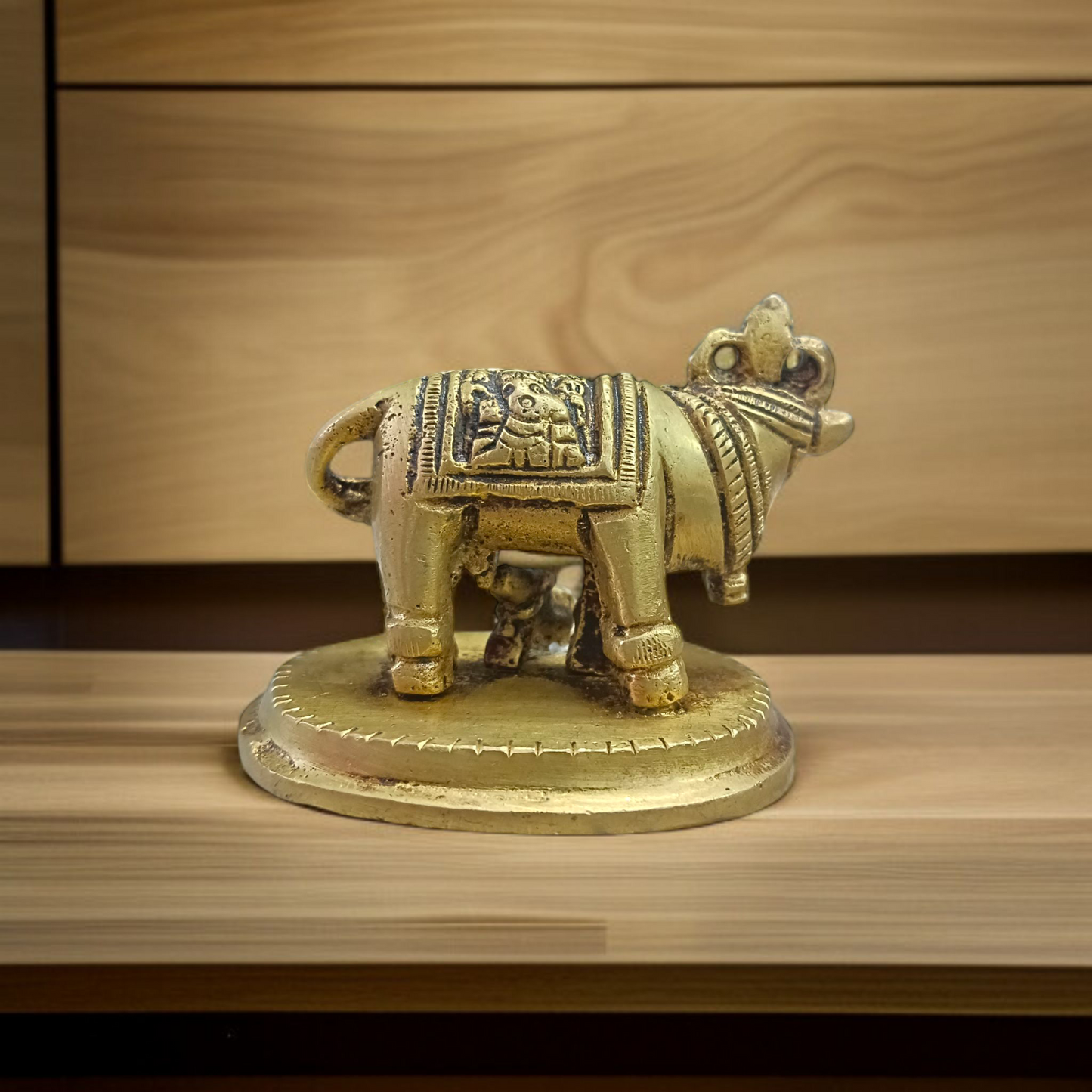 Brass Kamdhenu Cow Murti with calf and deities, ideal for spiritual rituals, pooja, and Vastu correction