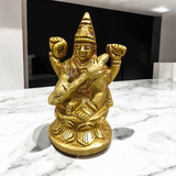 Brass Maa Saraswati Idol, featuring Goddess Saraswati with a veena, book, and rosary, beautifully crafted for spiritual worship and intellectual blessings.
