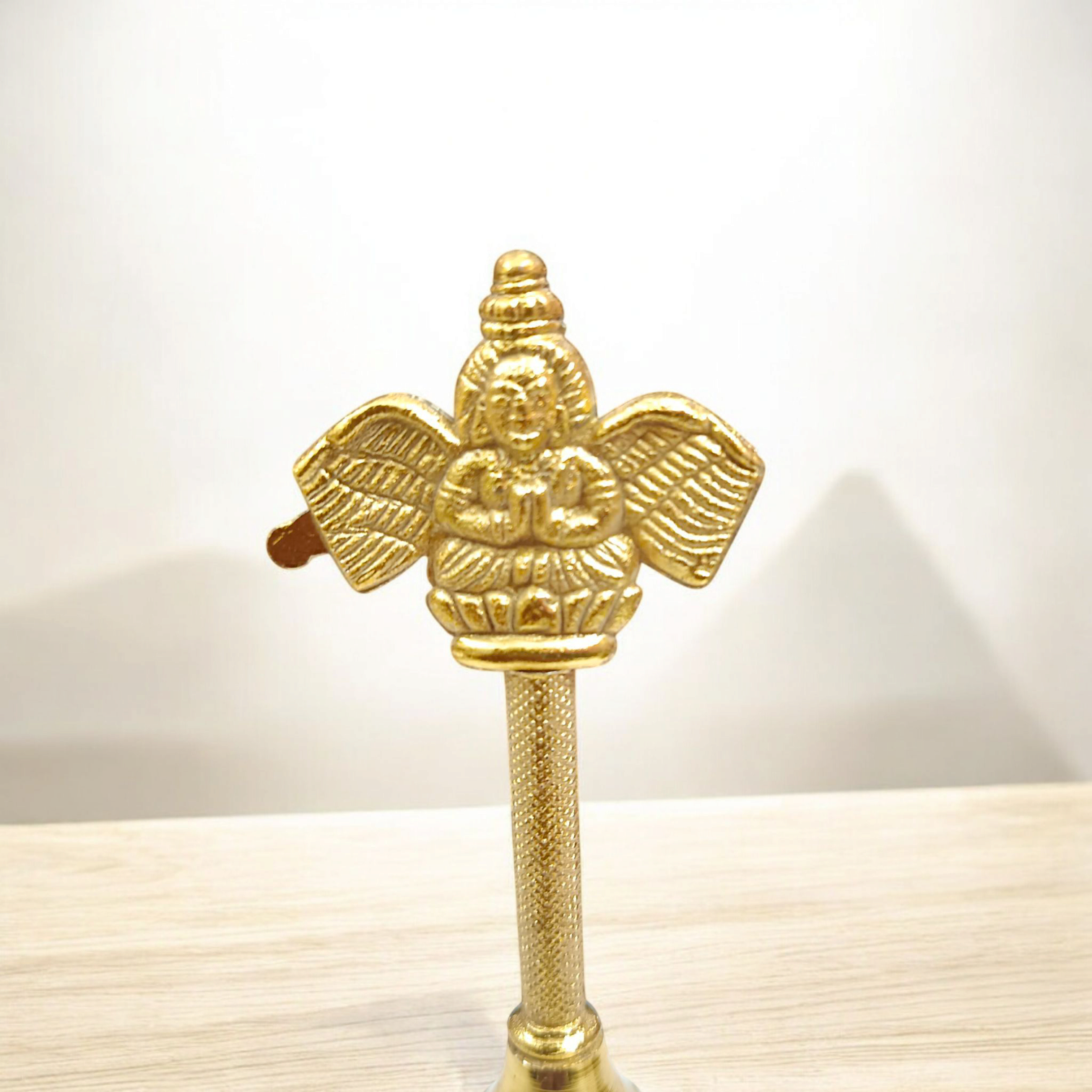 Brass Puja Bell with Garud design, perfect for spiritual rituals, pooja, and temple ceremonies.

