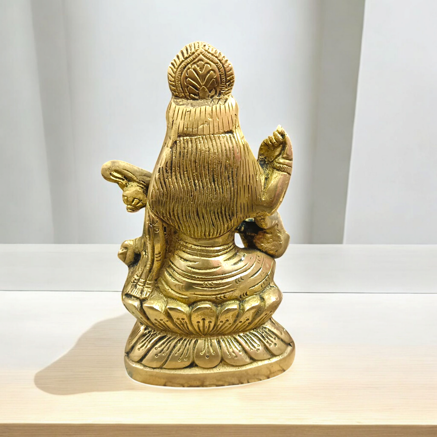 Brass Saraswati Murti Idol, a beautifully detailed statue of Goddess Saraswati, made from brass, with intricate craftsmanship, holding a veena.
