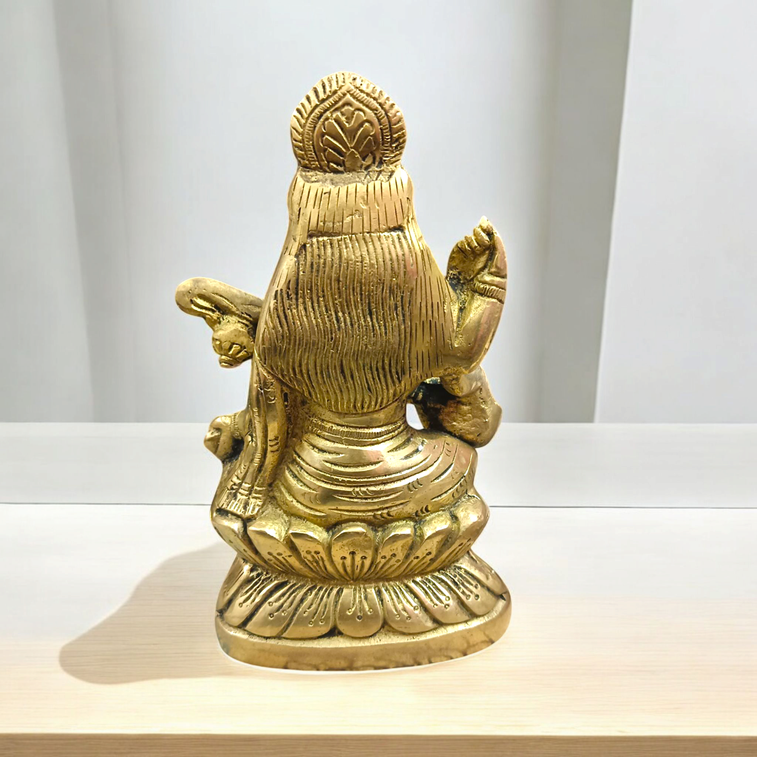 Brass Saraswati Murti Idol, a beautifully detailed statue of Goddess Saraswati, made from brass, with intricate craftsmanship, holding a veena.