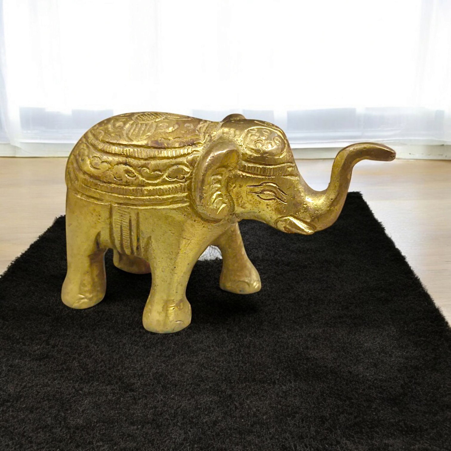 Brass elephant statue symbolizing wisdom, success, and prosperity, intricately crafted for office decor.