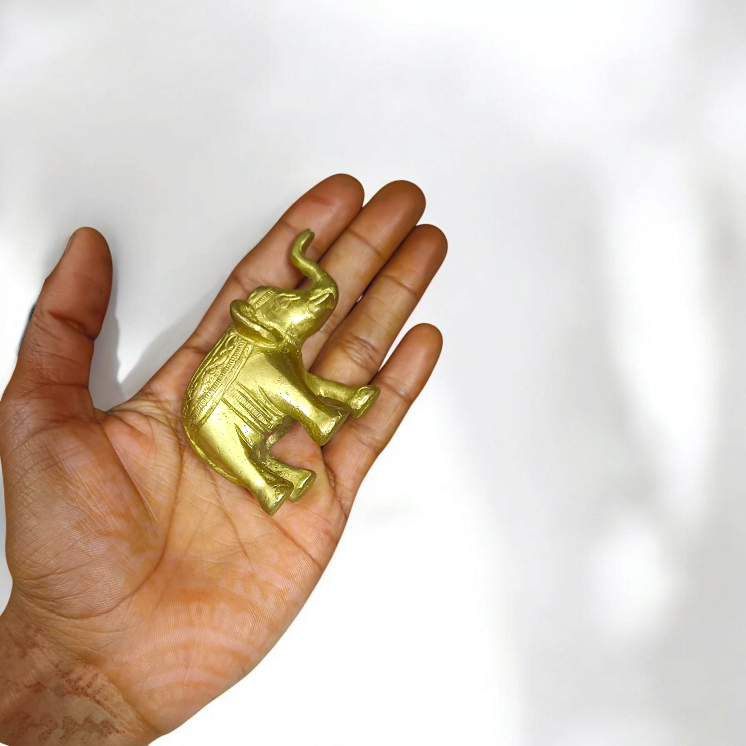Brass elephant statue symbolizing wisdom, success, and prosperity, intricately crafted for office decor.