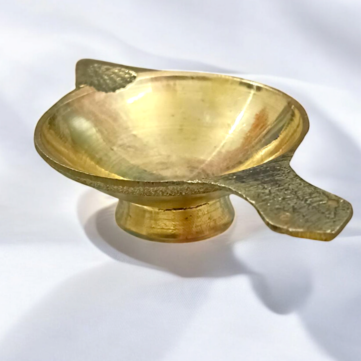 Brass oil lamp (Brass Jyot) designed for pooja rituals, showcasing a steady flame with a traditional and elegant design.