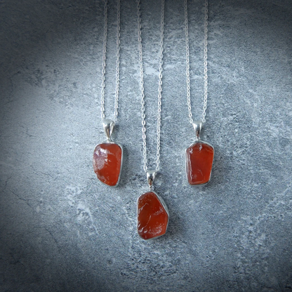 Carnelian Stone Pendant made from raw Carnelian crystal on a chain, designed to boost energy, creativity, and emotional balance.