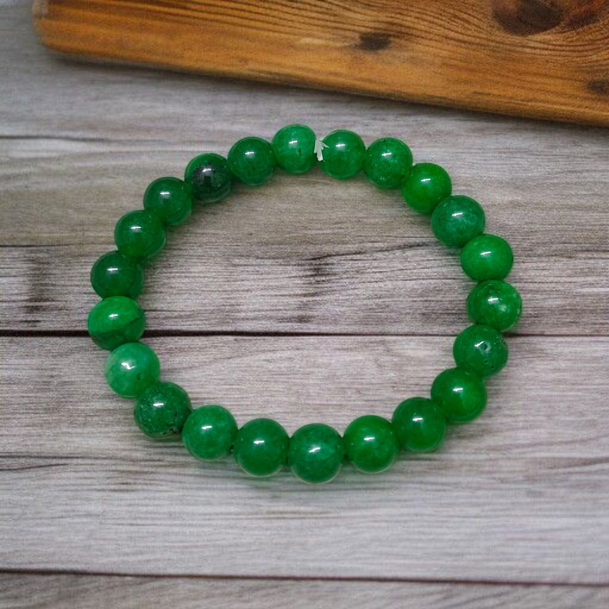 Close-up image of a Green Onyx Bracelet featuring polished 8mm beads on a stretchable band