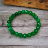 Close-up image of a Green Onyx Bracelet featuring polished 8mm beads on a stretchable band