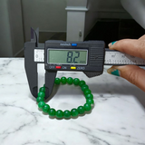 Close-up image of a Green Onyx Bracelet featuring polished 8mm beads on a stretchable band