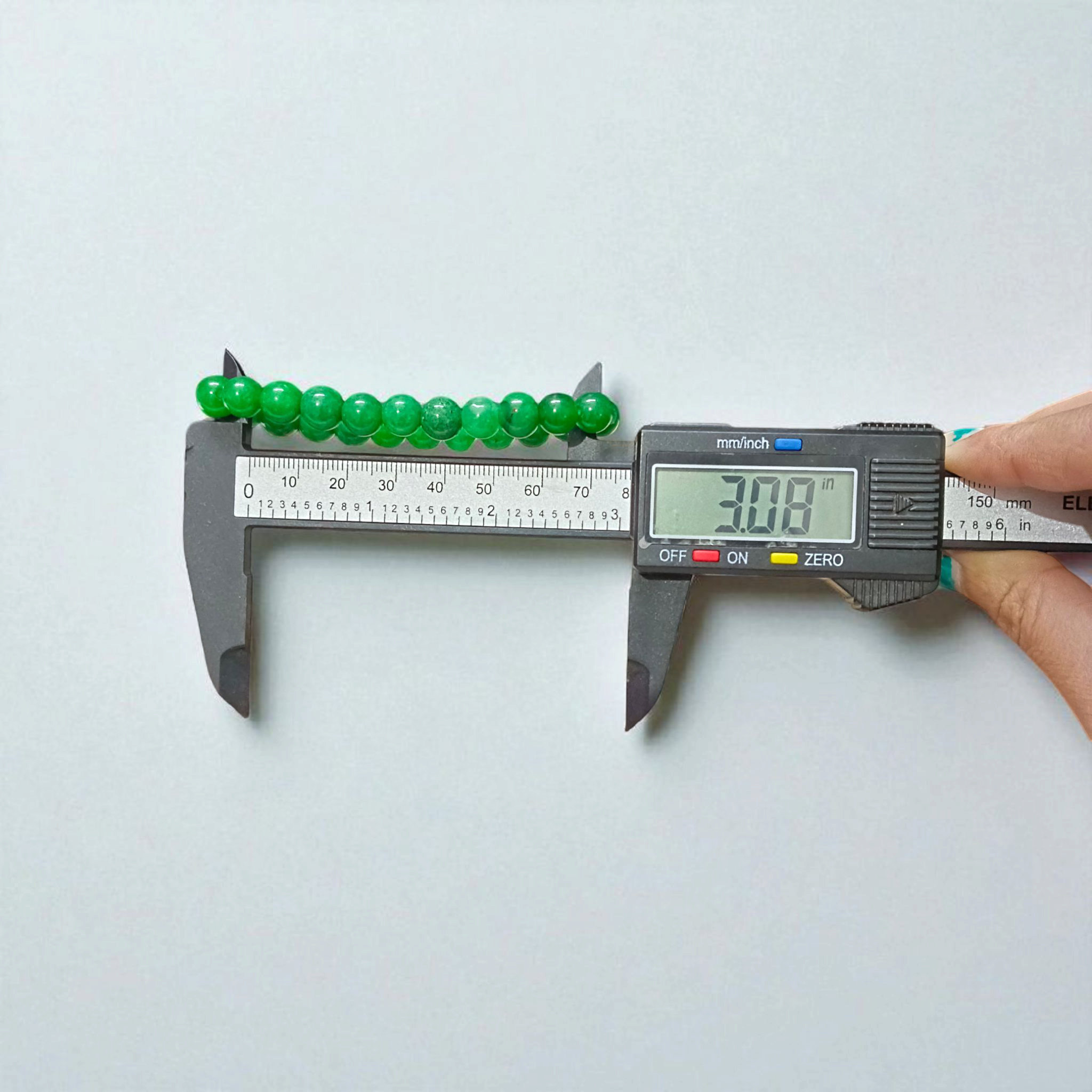 Close-up image of a Green Onyx Bracelet featuring polished 8mm beads on a stretchable band