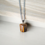 Close-up image of a Tiger Eye Pendant with chain, showcasing the natural golden-brown bands of the stone, ideal for daily wear and spiritual protection