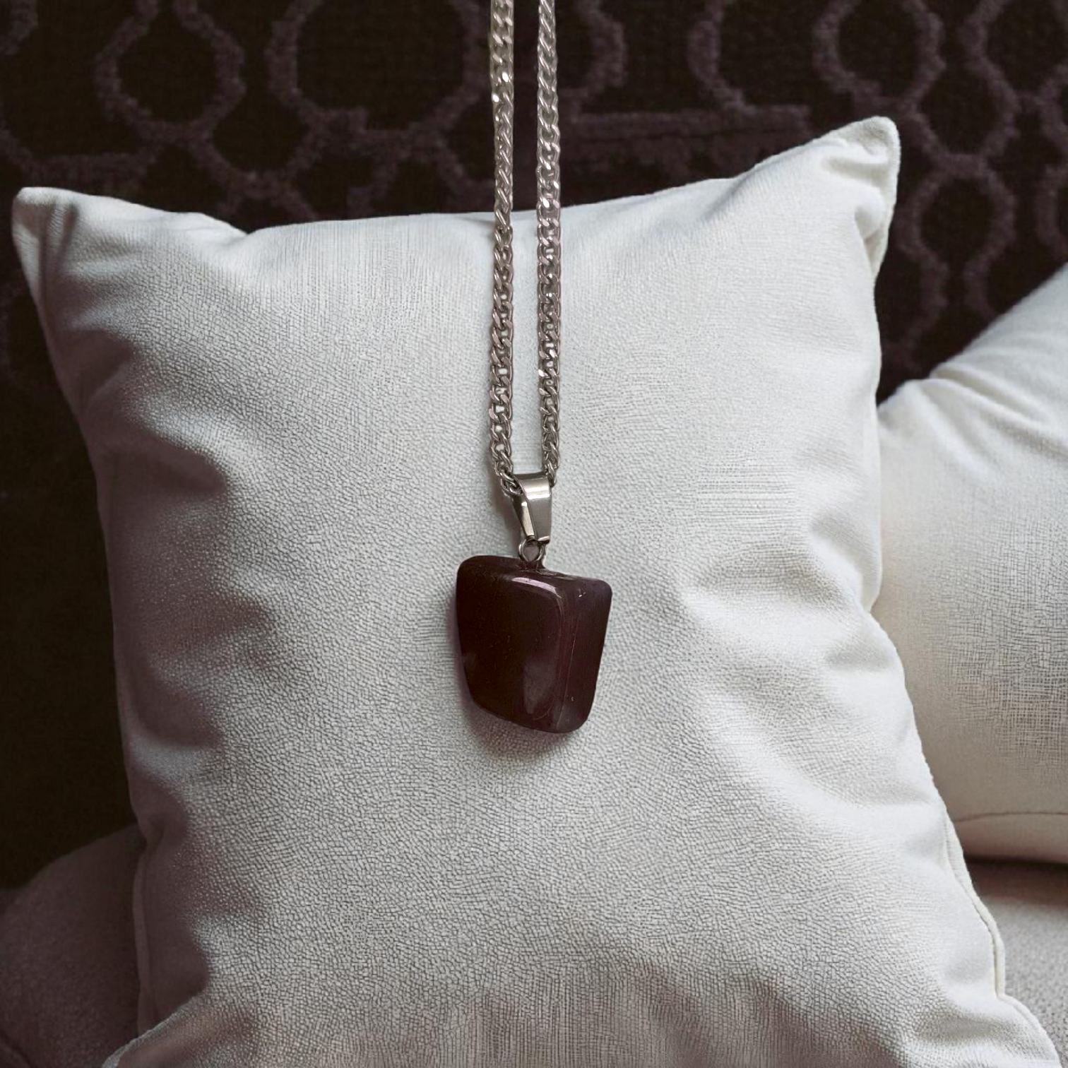 Close-up of lab-certified deep red Almandine Garnet pendant in elegant silver setting, ideal for daily wear and spiritual use
