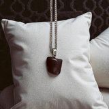 Close-up of lab-certified deep red Almandine Garnet pendant in elegant silver setting, ideal for daily wear and spiritual use
