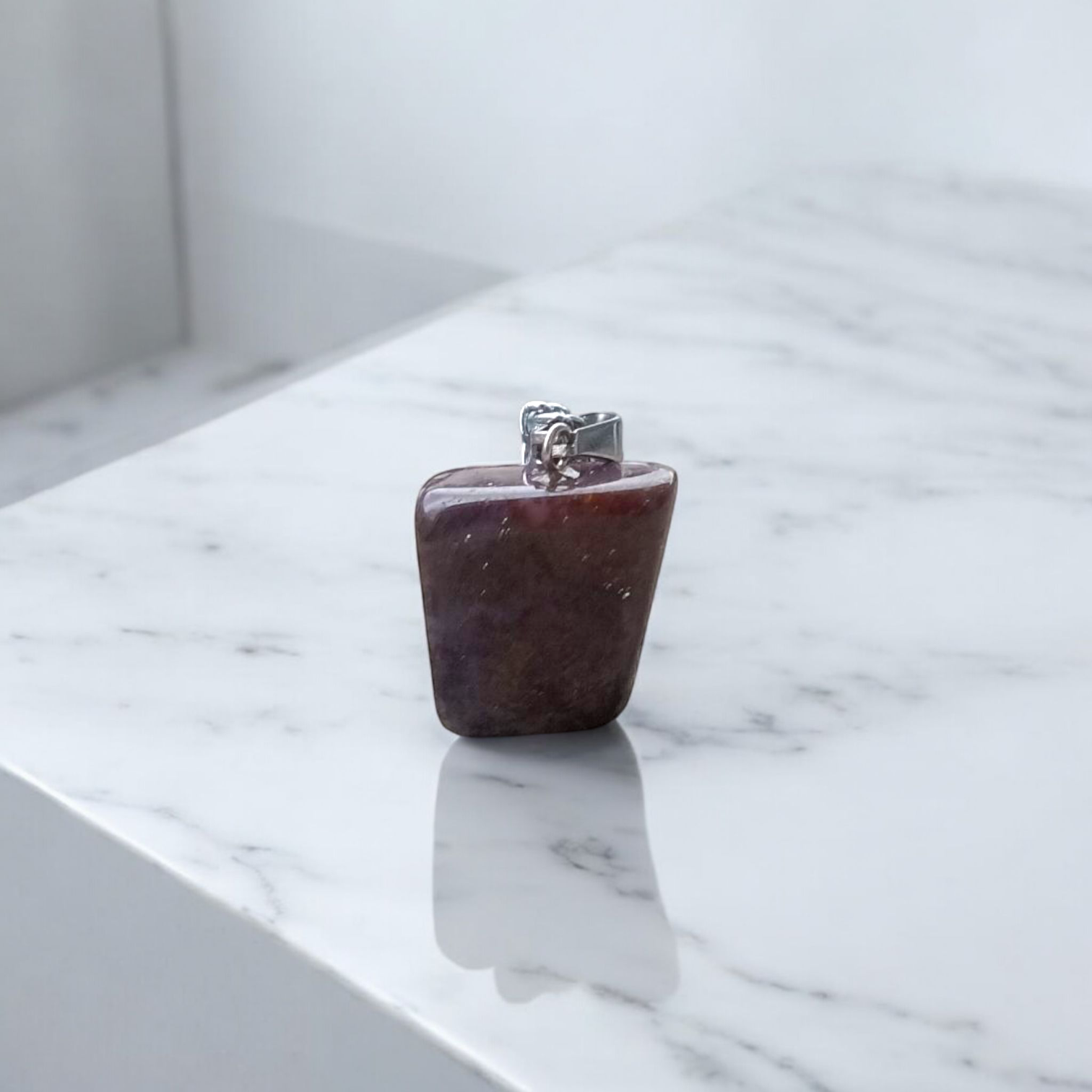 Close-up of lab-certified deep red Almandine Garnet pendant in elegant silver setting, ideal for daily wear and spiritual use