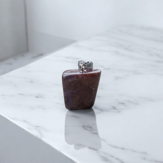 Close-up of lab-certified deep red Almandine Garnet pendant in elegant silver setting, ideal for daily wear and spiritual use