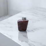 Close-up of lab-certified deep red Almandine Garnet pendant in elegant silver setting, ideal for daily wear and spiritual use