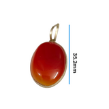 Close-up of the Original Orange Aventurine Pendant on a necklace, showing its vibrant orange hue and smooth, polished surface.