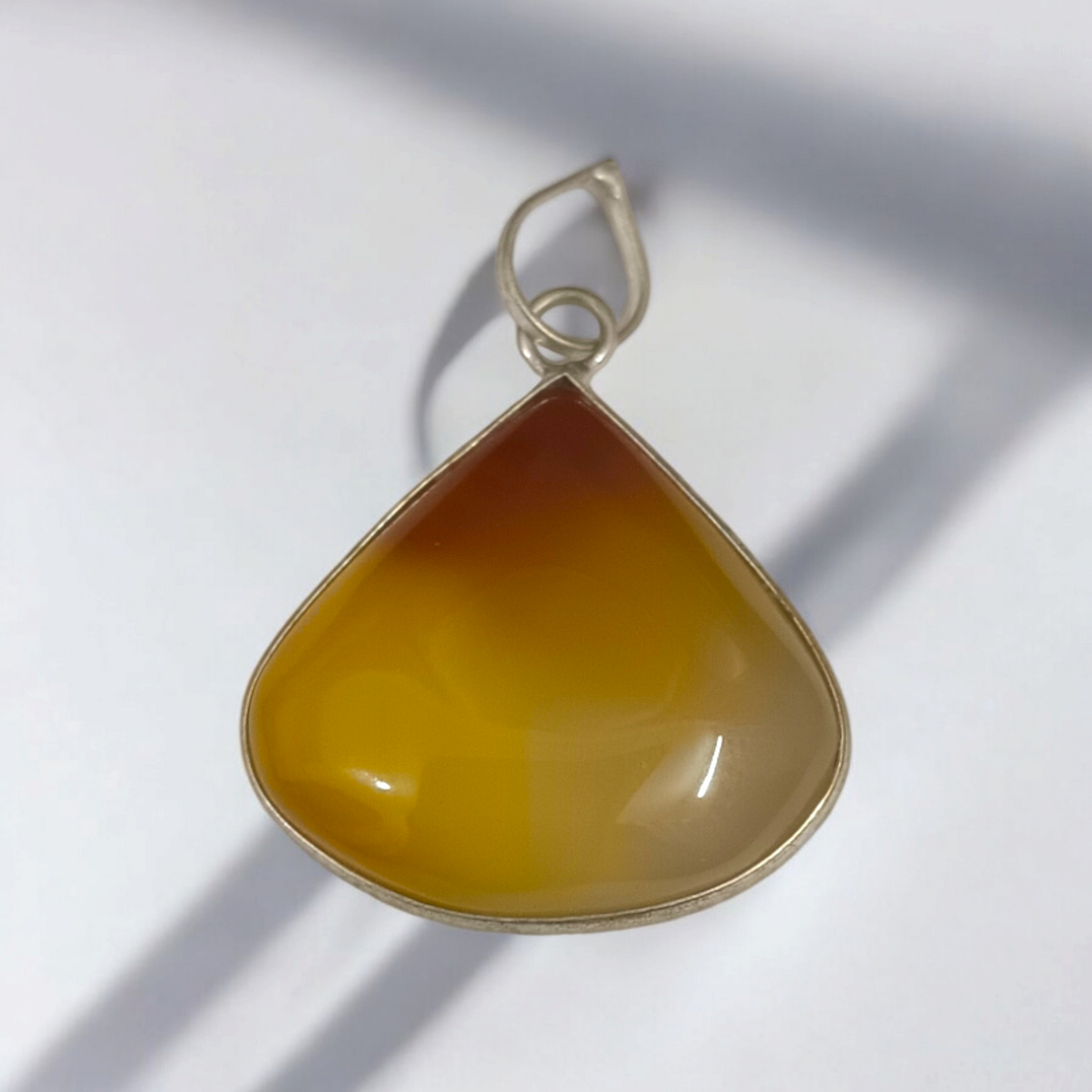 Close-up_of_the_Original_Yellow_Aventurine_Pendant_highlighting_its_smooth_vibrant_yellow_hue_and_polished_surface_on_a_necklace