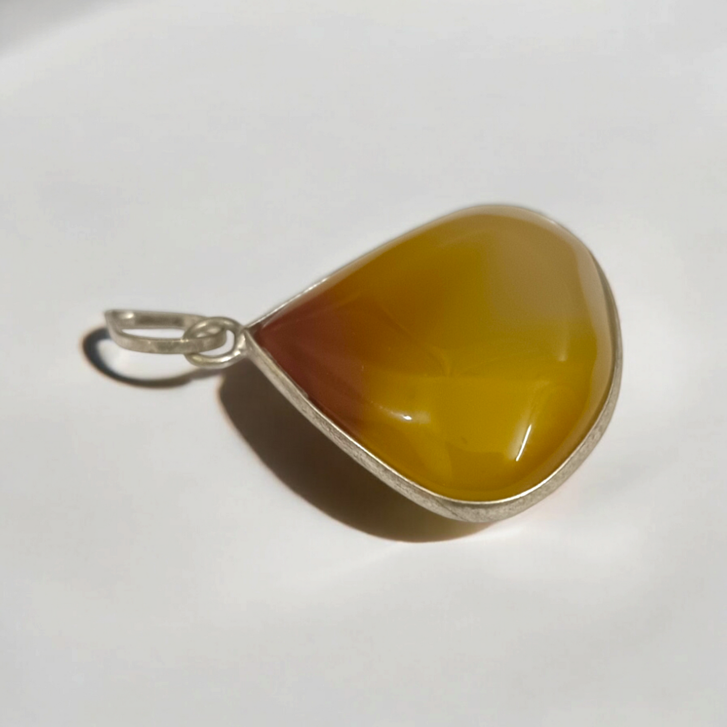 Close-up_of_the_Original_Yellow_Aventurine_Pendant_highlighting_its_smooth_vibrant_yellow_hue_and_polished_surface_on_a_necklace