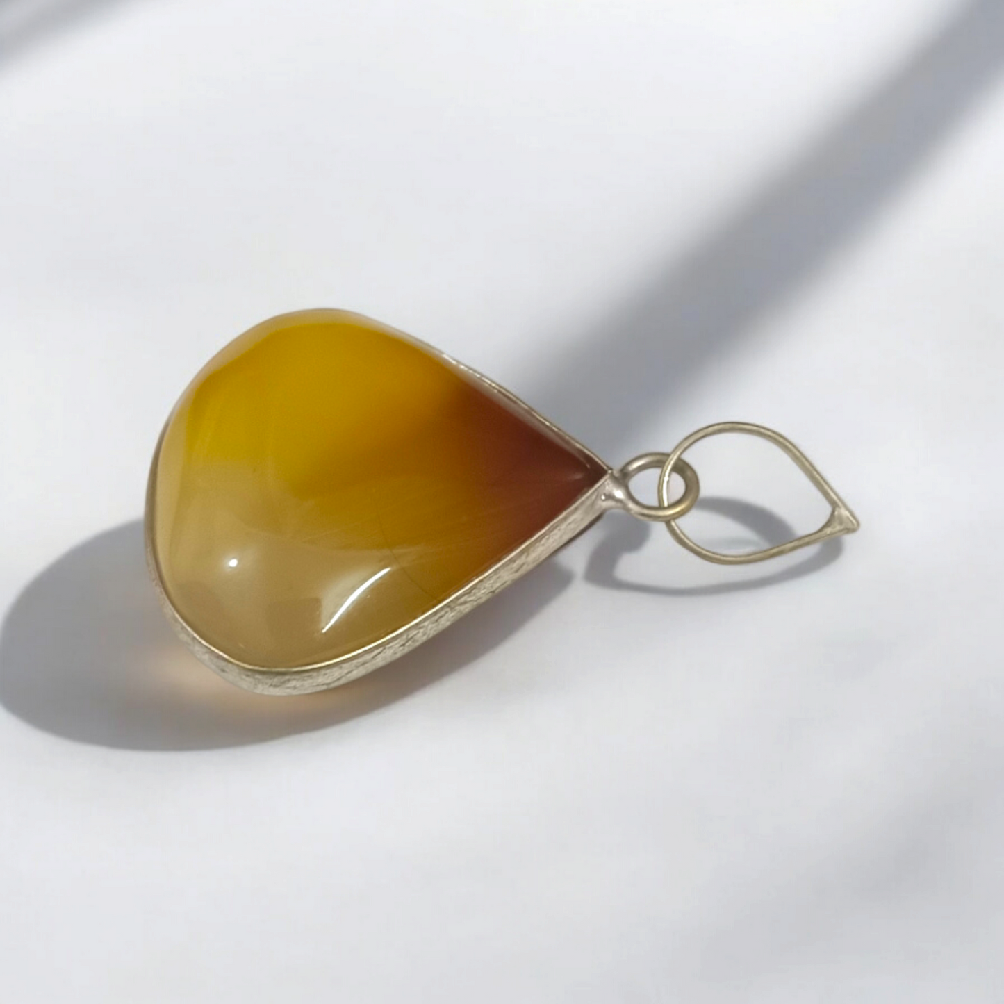 Close-up_of_the_Original_Yellow_Aventurine_Pendant_highlighting_its_smooth_vibrant_yellow_hue_and_polished_surface_on_a_necklace