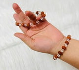 Crystal Rudraksha Bracelet with 8MM beads of natural rudraksha and clear quartz, stretchable design, and authenticity certificate for spiritual benefits.