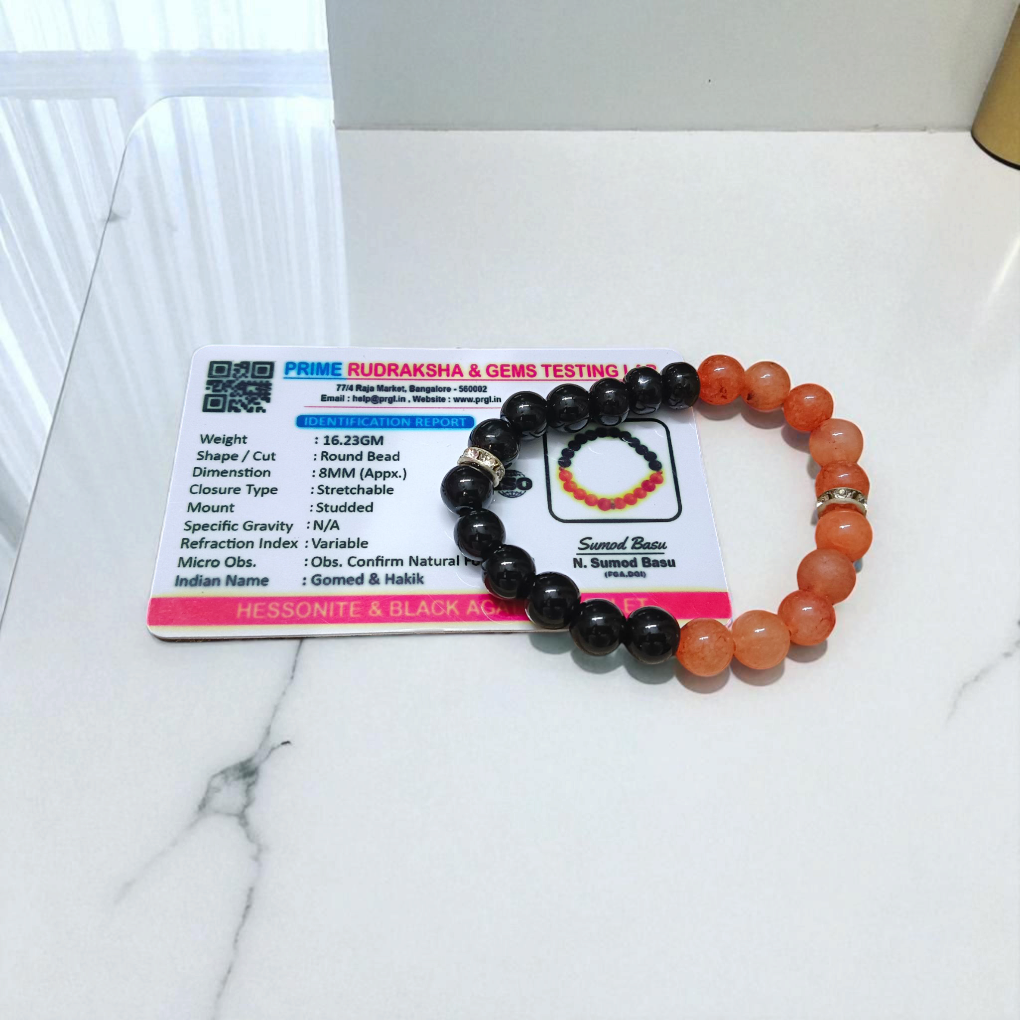 Description of the image: A beautiful Hessonite and Black Agate Bracelet featuring 8MM beads in a stretchable design with natural stones for spiritual healing
