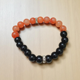 Description of the image: A beautiful Hessonite and Black Agate Bracelet featuring 8MM beads in a stretchable design with natural stones for spiritual healing