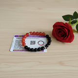 Description of the image: A beautiful Hessonite and Black Agate Bracelet featuring 8MM beads in a stretchable design with natural stones for spiritual healing