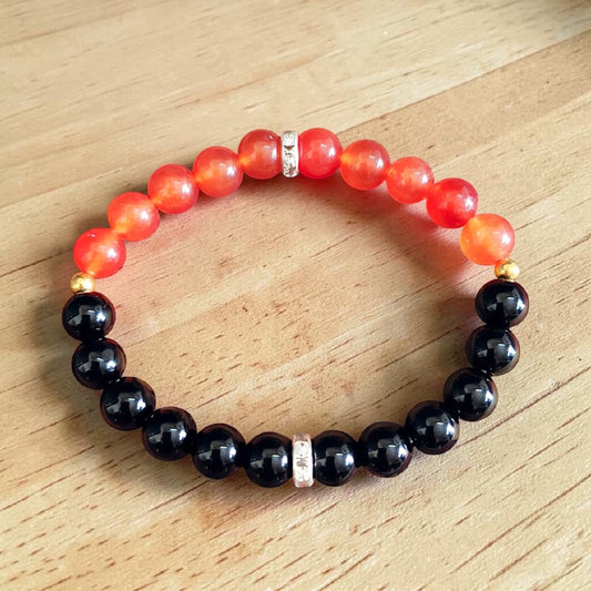 Description of the image: A beautiful Hessonite and Black Agate Bracelet featuring 8MM beads in a stretchable design with natural stones for spiritual healing