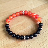 Description of the image: A beautiful Hessonite and Black Agate Bracelet featuring 8MM beads in a stretchable design with natural stones for spiritual healing
