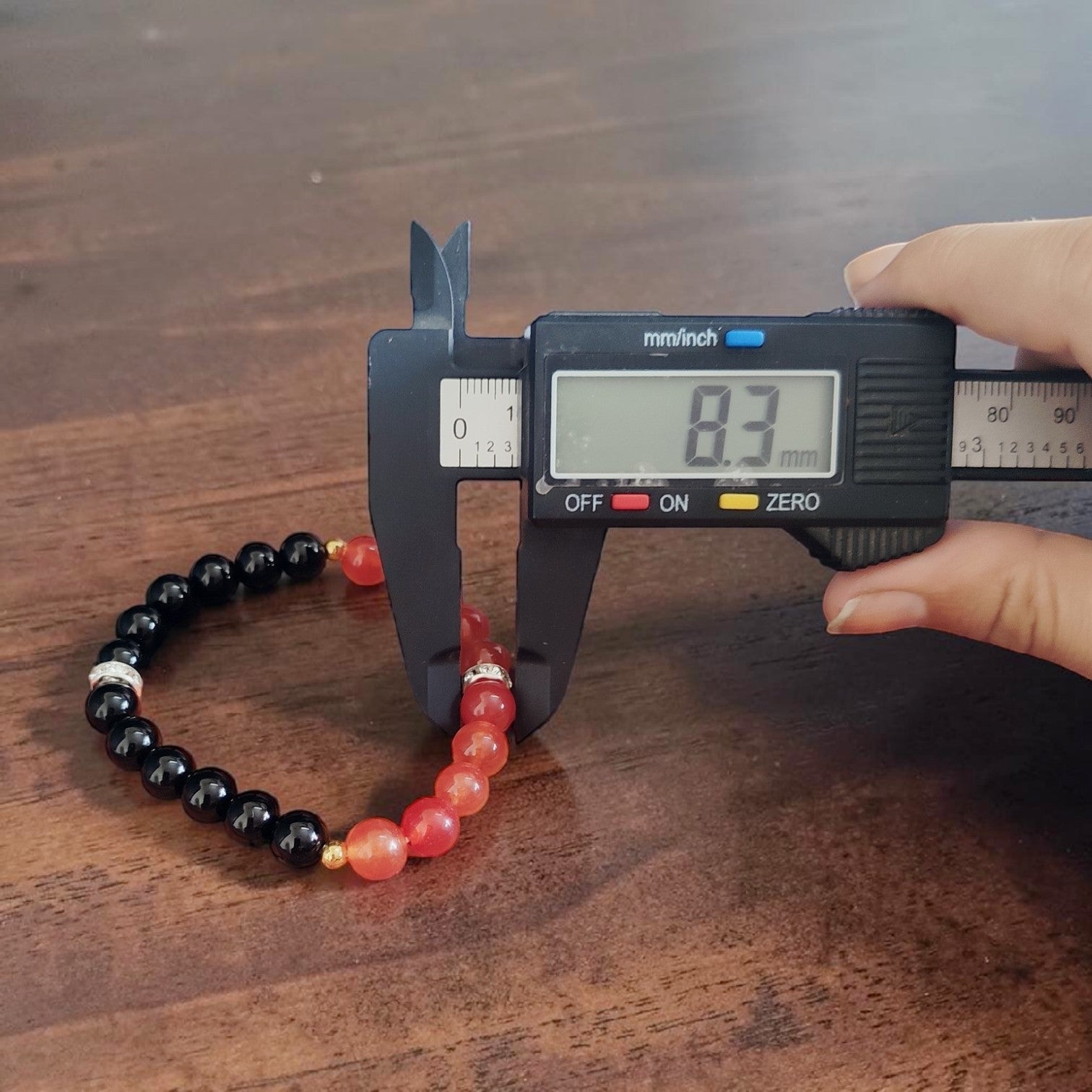Description of the image: A beautiful Hessonite and Black Agate Bracelet featuring 8MM beads in a stretchable design with natural stones for spiritual healing