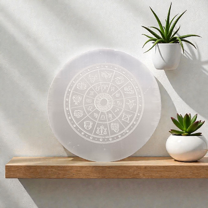 Engraved selenite crystal charging plate with zodiac signs, used for cleansing and recharging crystals, meditation, pooja, and spiritual home décor