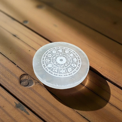 Engraved selenite crystal charging plate with zodiac signs, used for cleansing and recharging crystals, meditation, pooja, and spiritual home décor