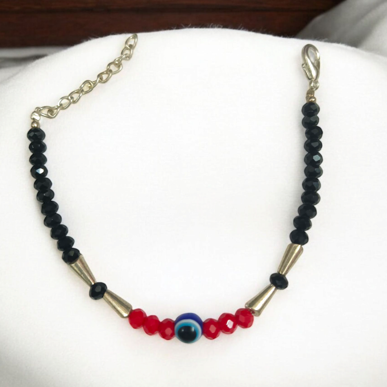 Evil Eye Anklet for Kids with black and red beads, designed for spiritual protection and good luck.
