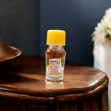 Glass bottle of Raat Rani Attar (1ML) by Veena, natural floral perfume for spiritual and worship use, displayed on a soft background with jasmine flowers