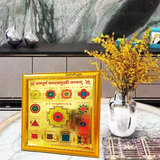 Gold-plated Sampoorna Baglamukhi Yantra with intricate details in a wooden frame, offering protection, prosperity, and divine blessings