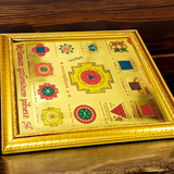 Gold-plated Sampoorna Baglamukhi Yantra with intricate details in a wooden frame, offering protection, prosperity, and divine blessings