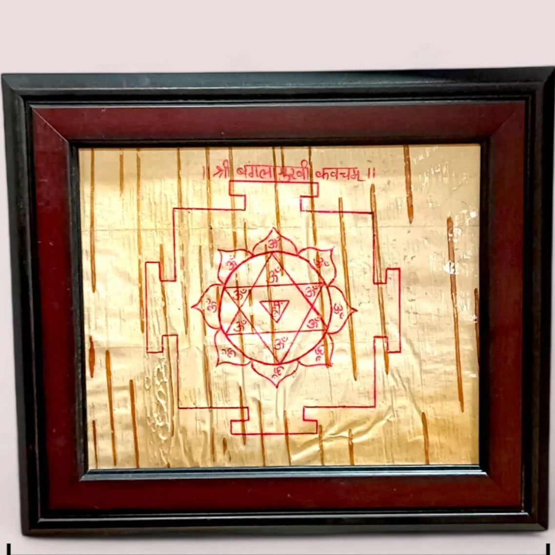 Handmade Baglamukhi Kawach engraved on Bhojpatra, framed in wood for spiritual protection and blessings, ideal for home or office.