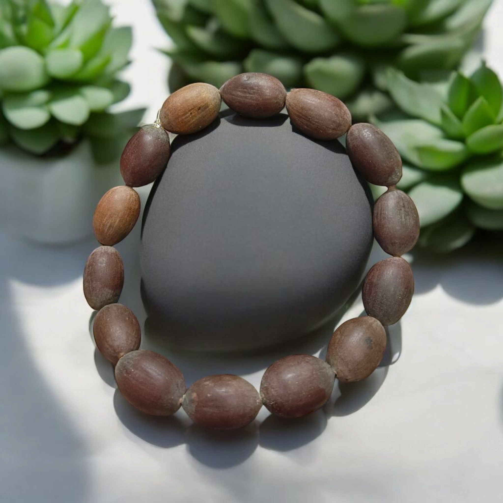 Image of Natural Kamal Gutta Bracelet made from 100% Original Lotus Seeds with Lab Certificate shown on a wrist for spiritual use